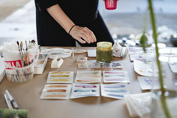 Biofabrique Vienna Challenge „Colors at Work” Person experimentiert auf Papier mit "Wiener Farben"