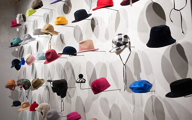 HutmodeBieser_cEvaSiebert Hutmode Biester: Viele unterschiedliche Hüte sind an einer Wand ausgestellt